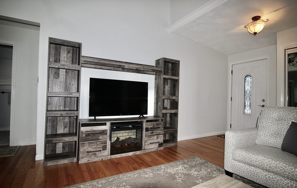 133 Hardy Pond Road Waltham, MA 02451 - Photo 8 of 30 a living room with furniture and a flat screen tv