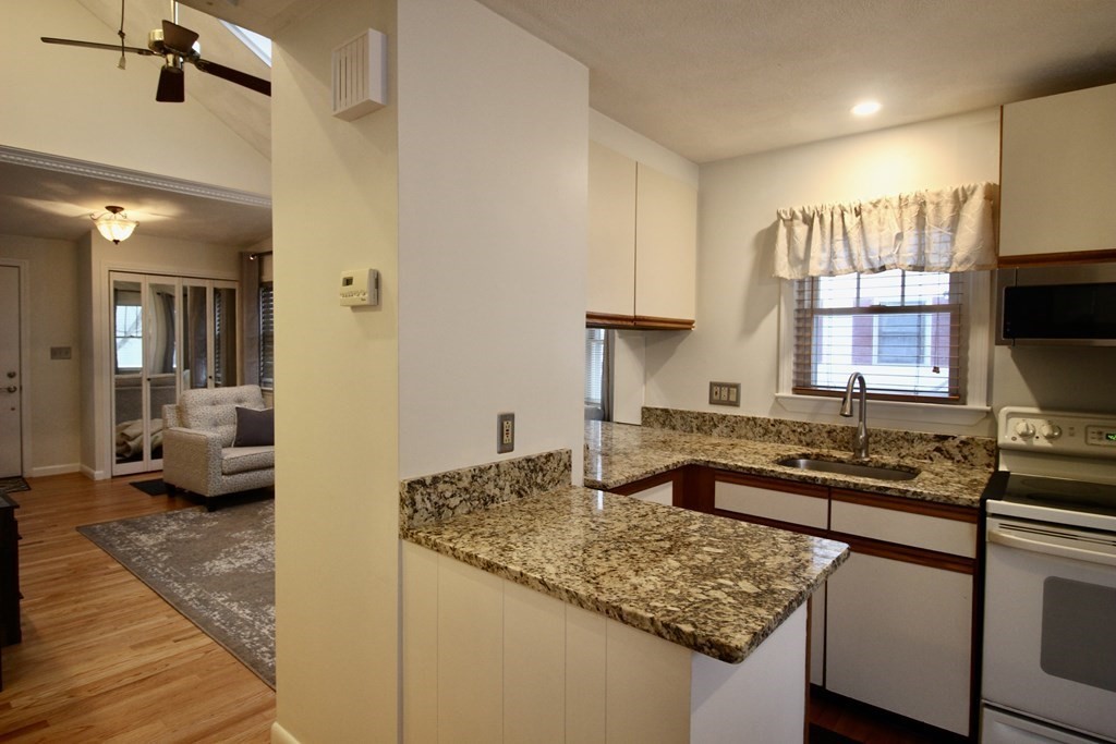 133 Hardy Pond Road Waltham, MA 02451 - Photo 10 of 30 a kitchen with a sink stove and refrigerator
