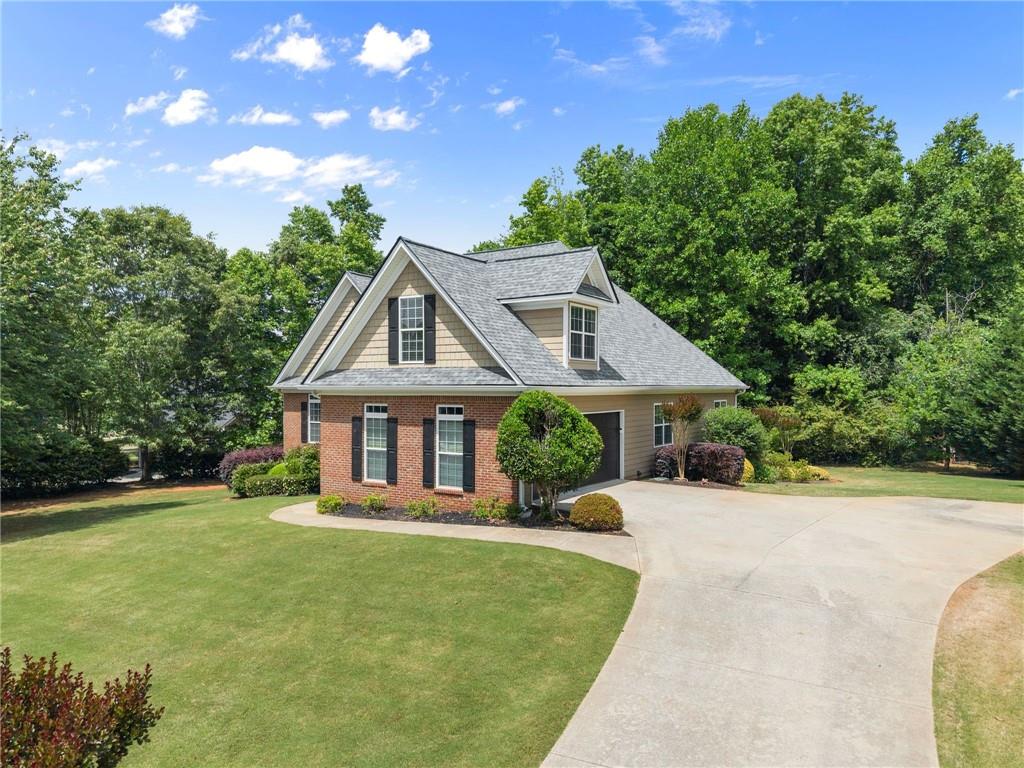6643 Windvane Point Clermont, GA 30527 - Photo 88 of 88 a front view of a house with a yard and trees