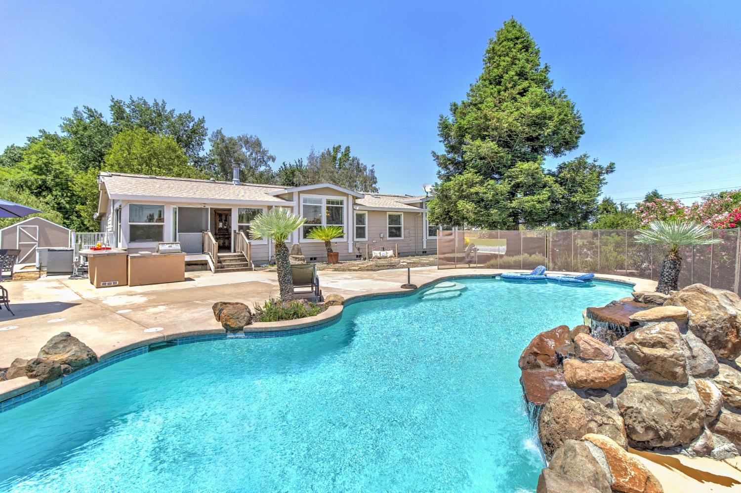 12390 Hobday Road Wilton, CA 95693 - Photo 53 of 92 a view of a house with swimming pool and porch