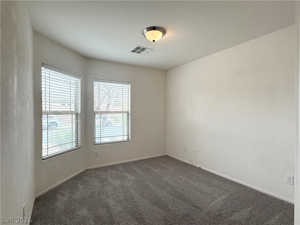 8231 Buffalo Ranch Avenue Las Vegas, NV 89147 - Photo 17 of 22 An inviting room with plush carpeting and natural light from multiple windows.