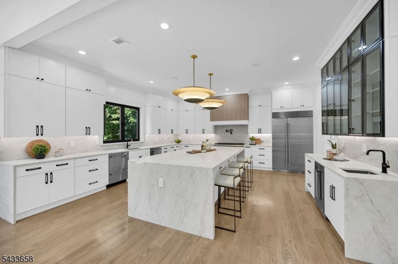 2 Orchard Road Florham Park, NJ 07932 - Photo 11 of 23 a large kitchen with kitchen island a white counter space a sink stainless steel appliances and cabinets