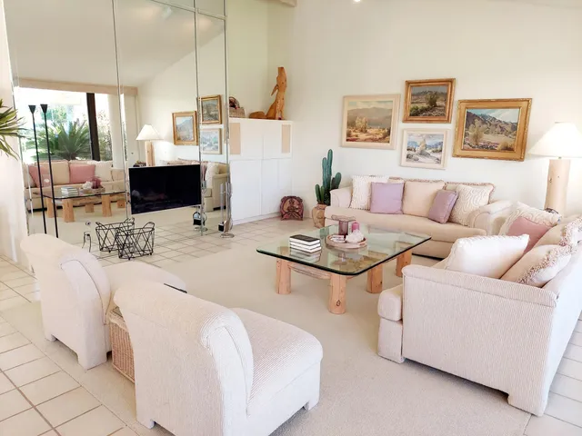 a kitchen with a sink dishwasher stove and white cabinets with wooden floor
