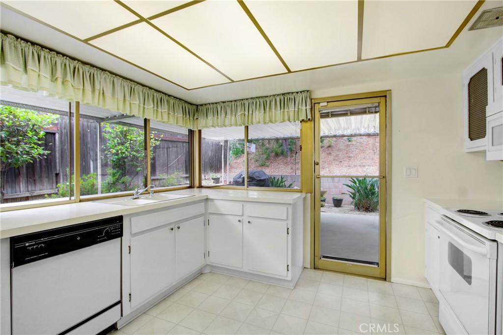 23848 Sunset Crossing Road Diamond Bar, CA 91765 - Photo 13 of 28 a kitchen with a sink and refrigerator