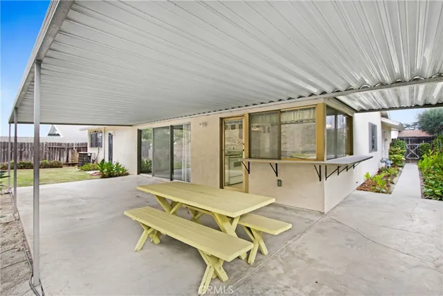a building outdoor space with patio furniture and potted plants