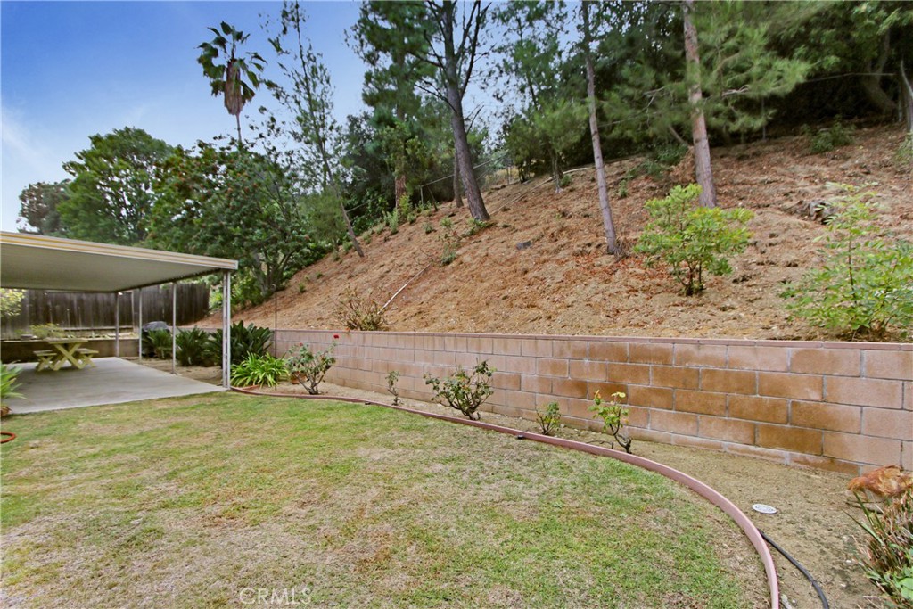 23848 Sunset Crossing Road Diamond Bar, CA 91765 - Photo 27 of 28 a backyard of a house with table and chairs
