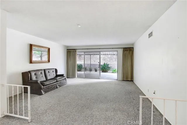 a view of a livingroom with furniture wooden floor and window