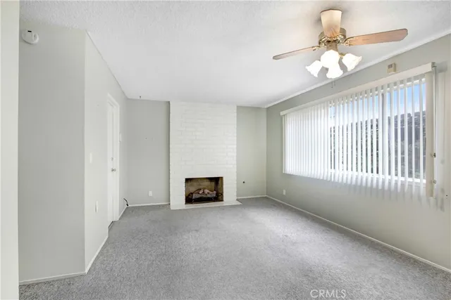 a view of main area fire place windows and cabinet