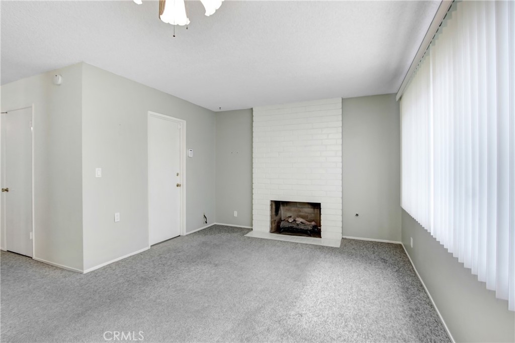 23848 Sunset Crossing Road Diamond Bar, CA 91765 - Photo 9 of 28 a view of an empty room with a window and a fireplace