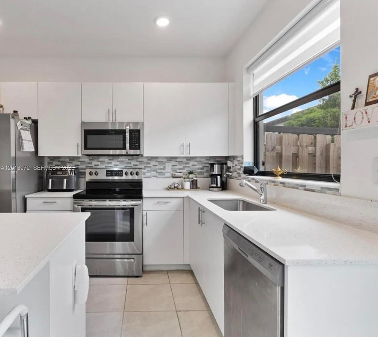 a kitchen with a sink stove and microwave