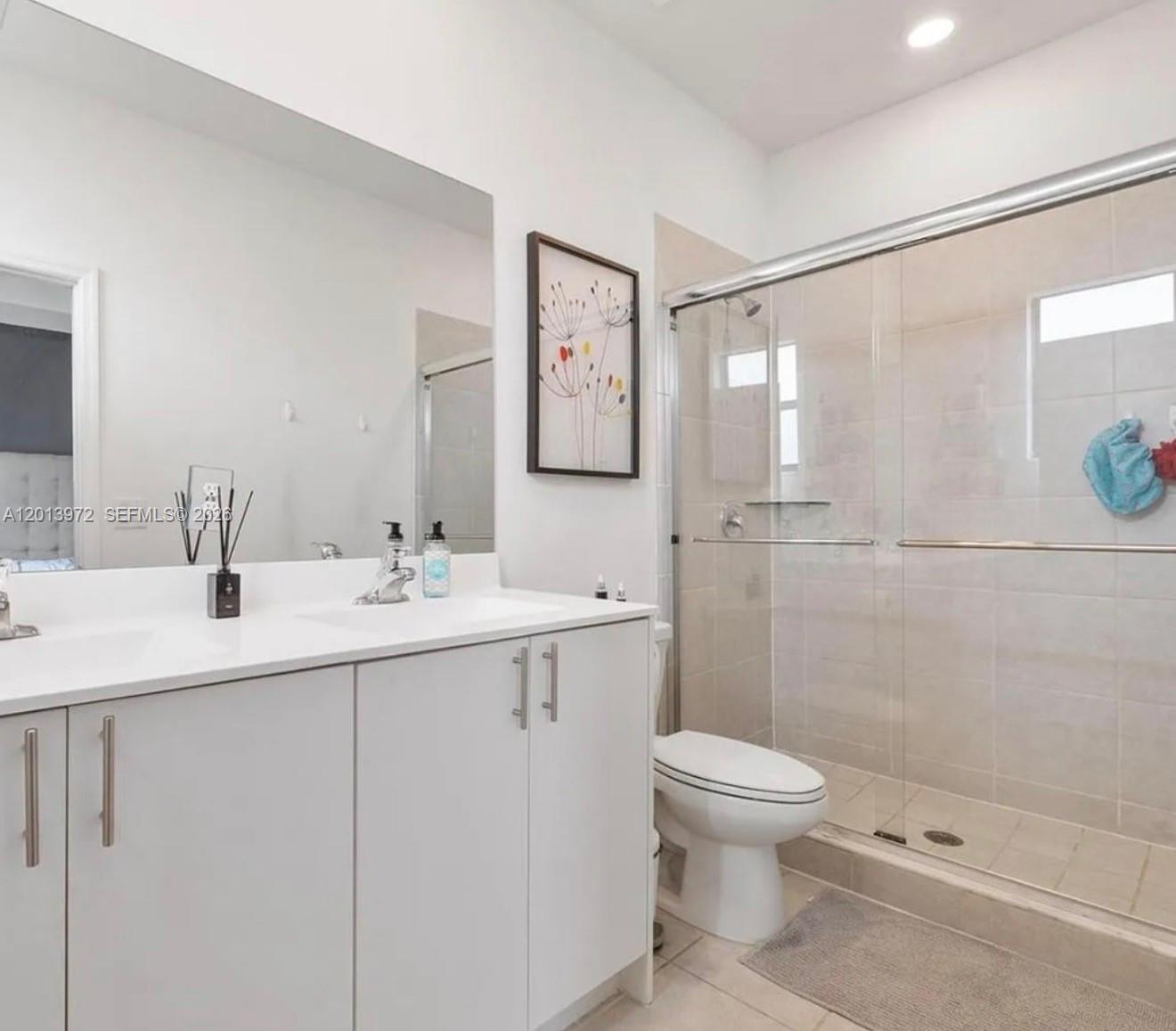 13250 Southwest 285th Street Homestead, FL 33033 - Photo 9 of 13 a bathroom with a toilet sink and mirror
