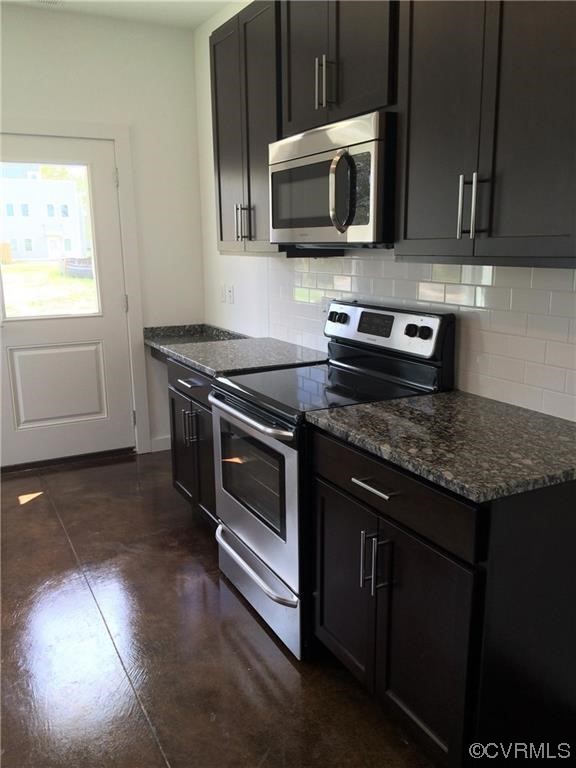 1104 Perry Street Richmond, VA 23224 - Photo 7 of 11 a kitchen with a stove and a microwave