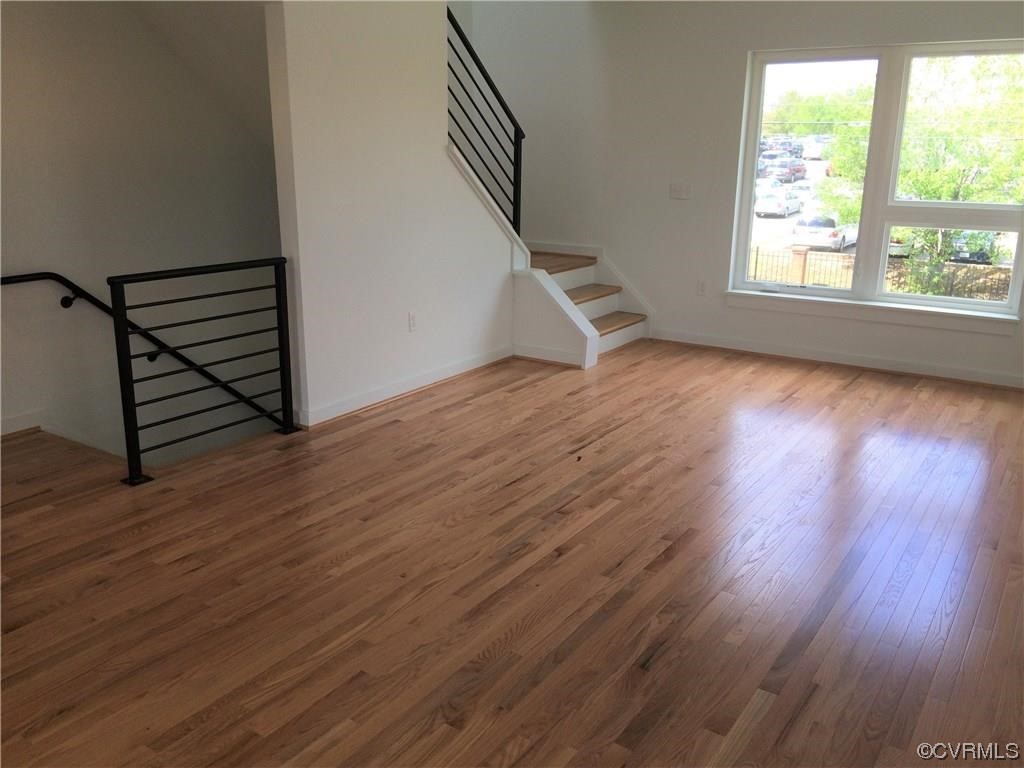 1104 Perry Street Richmond, VA 23224 - Photo 10 of 11 an empty room with wooden floor and windows