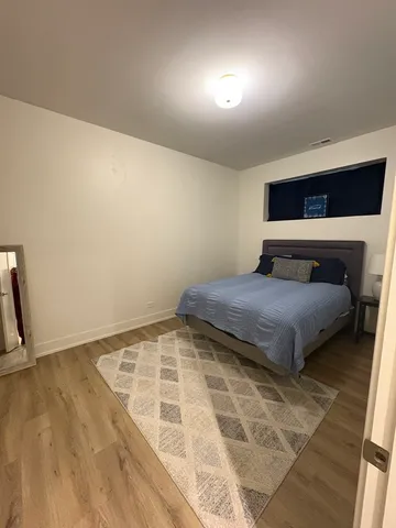 a bedroom with a bed and a night stand