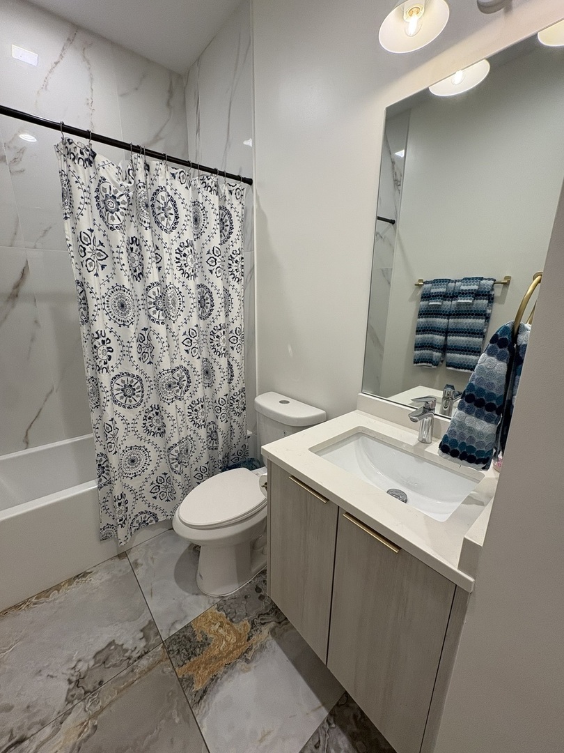6317 South Rhodes Avenue, Unit G Chicago, IL 60637 - Photo 10 of 14 a bathroom with a sink toilet and shower