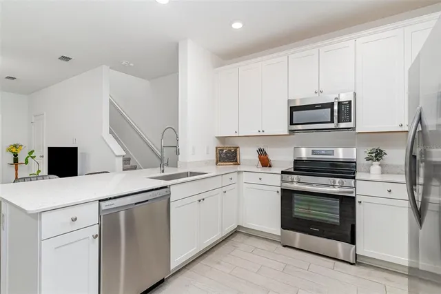 a kitchen with a sink stove and microwave