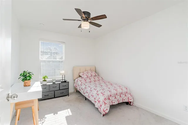 a bedroom with a bed furniture and a potted plant