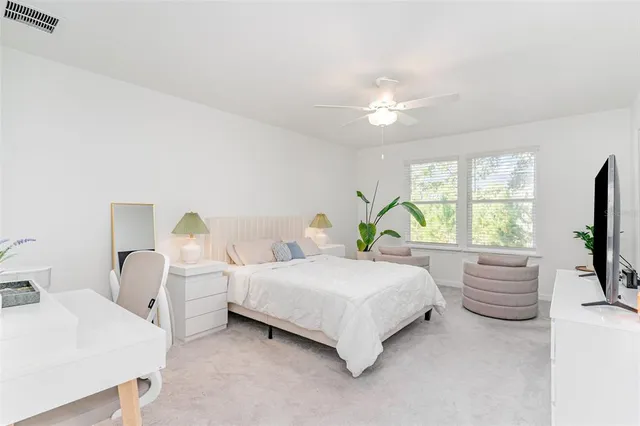 a bedroom with bed and a large window