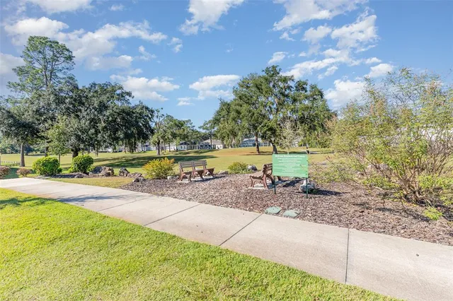 a view of a yard with swimming pool and sitting area