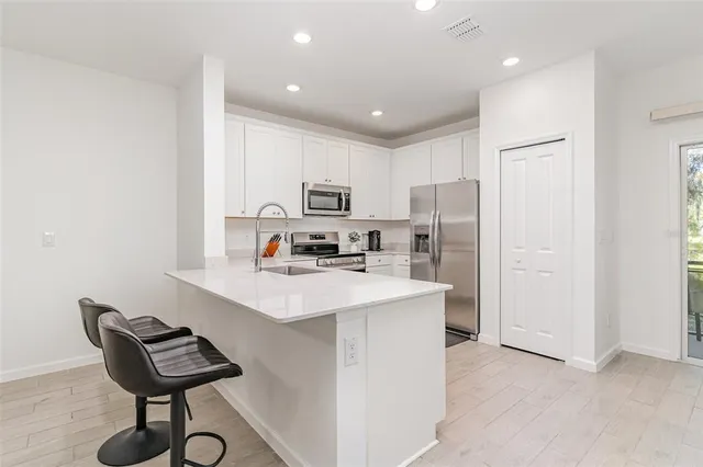 a kitchen with a refrigerator a sink and a stove