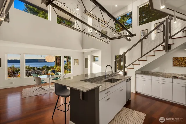 a kitchen with stainless steel appliances granite countertop a sink and stove