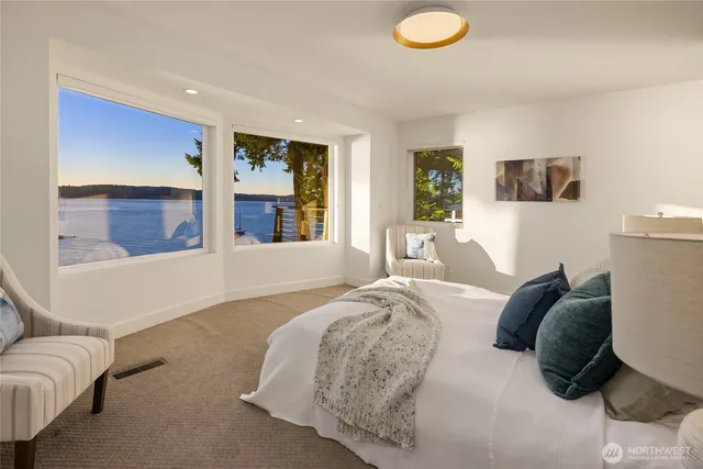 a bedroom with a large bed and a couch