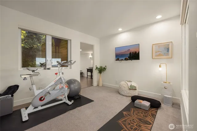 a room with gym equipment and a flat screen tv