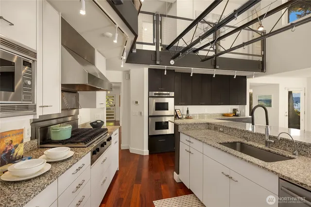 a kitchen with a sink stove and cabinets
