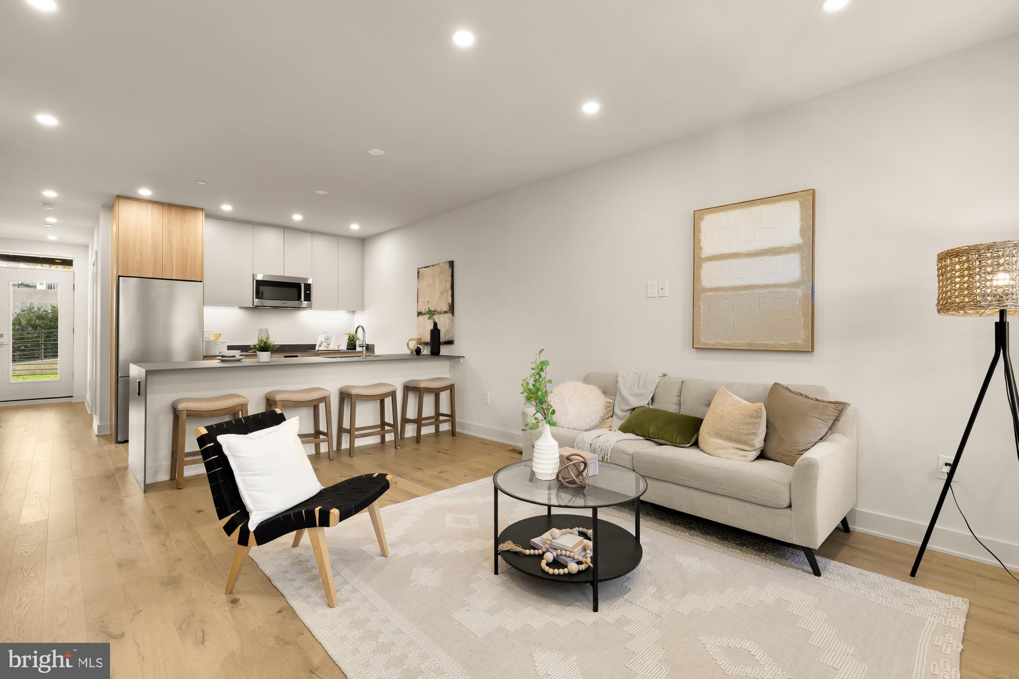 a living room with furniture and kitchen view
