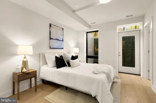 a bedroom with a bed and a lamp