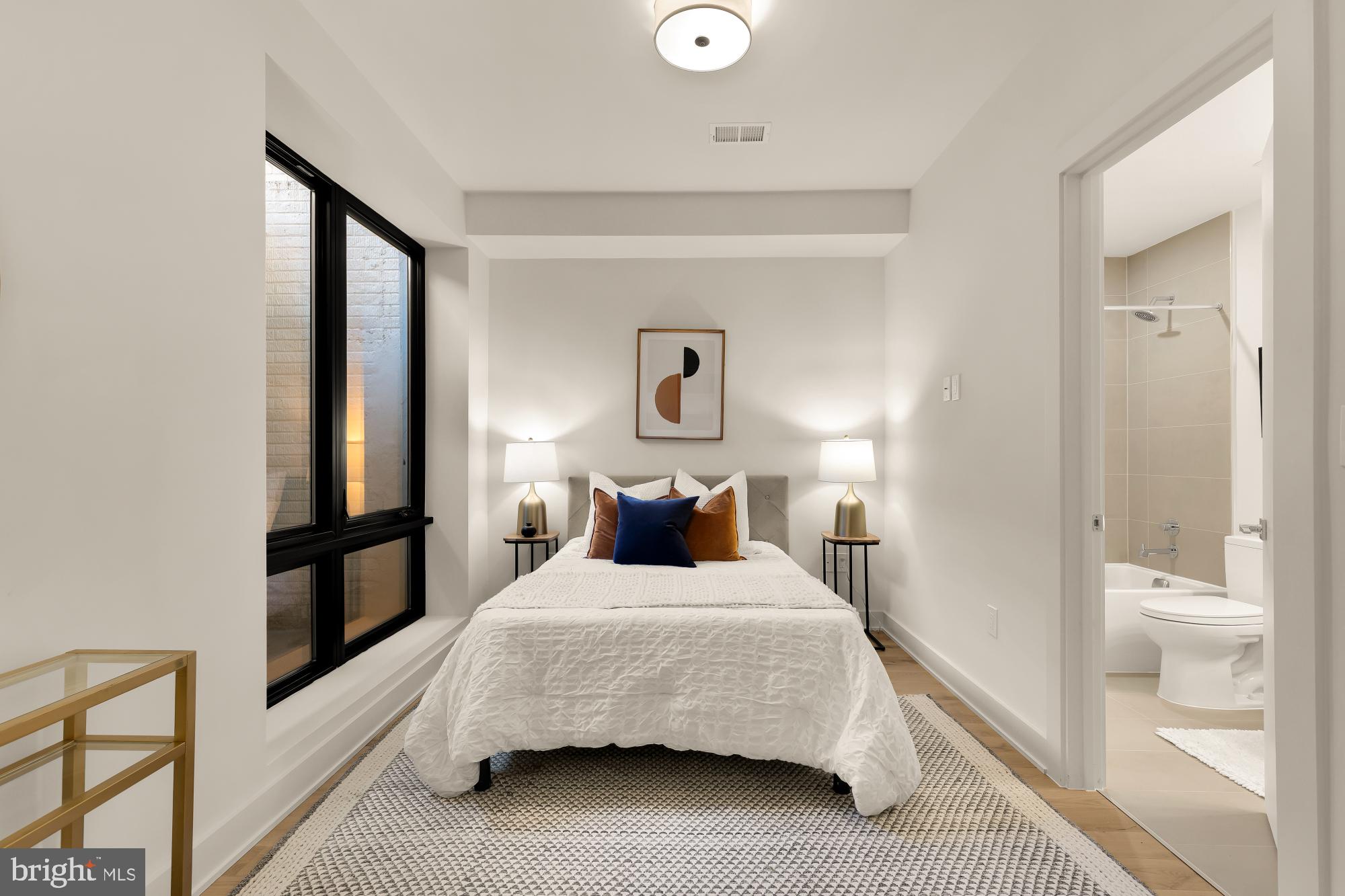 2647 41st Street Northwest, Unit 2 Washington, DC 20007 - Photo 24 of 31 a bedroom with a bed and a lamp on dresser
