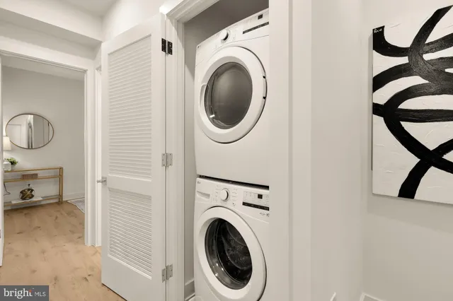 a view of a bedroom with washer and dryer