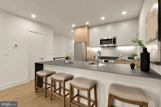 a kitchen with kitchen island granite countertop a sink and counter space