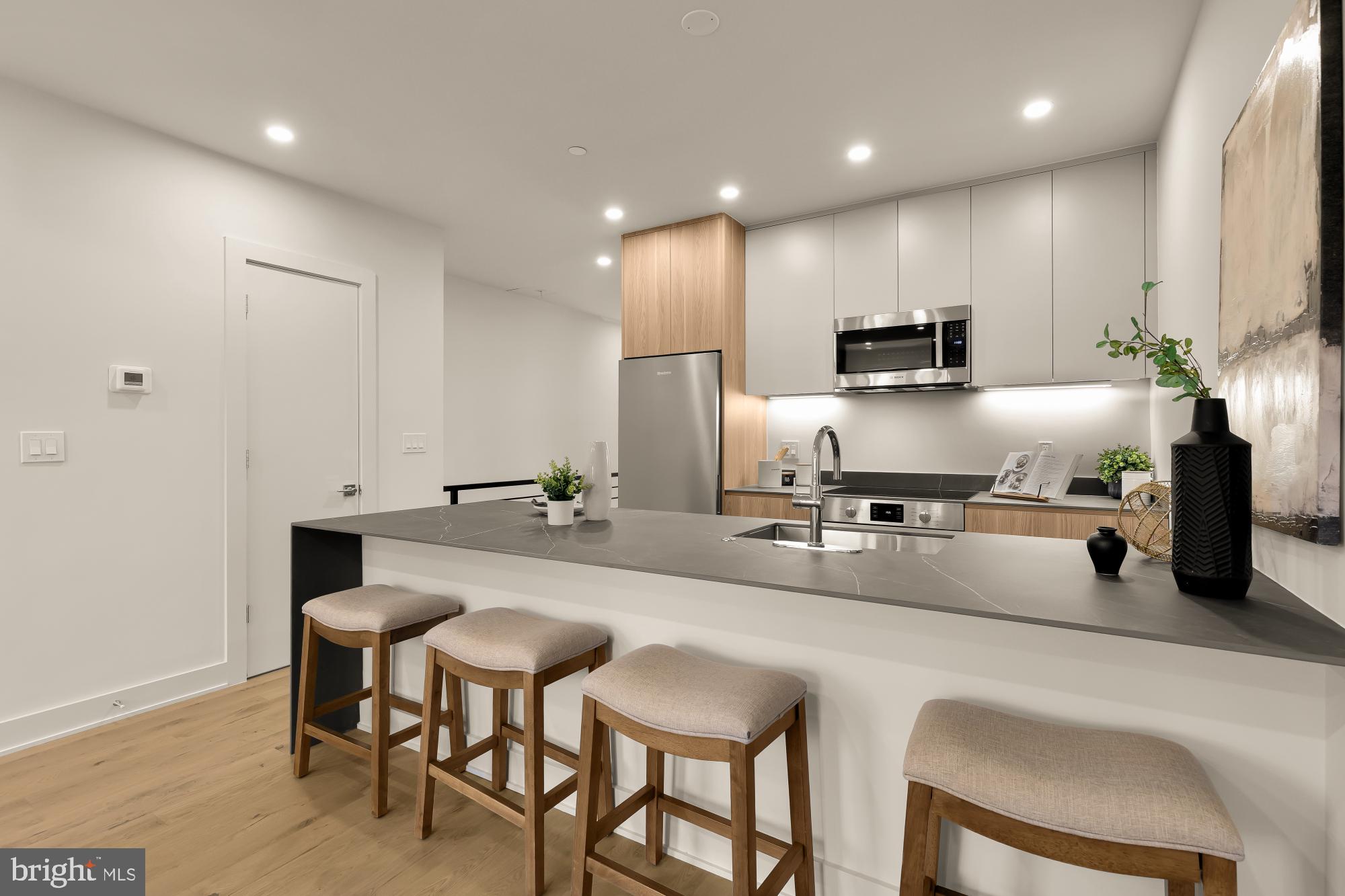2647 41st Street Northwest, Unit 2 Washington, DC 20007 - Photo 4 of 31 a kitchen with kitchen island granite countertop a sink and counter space