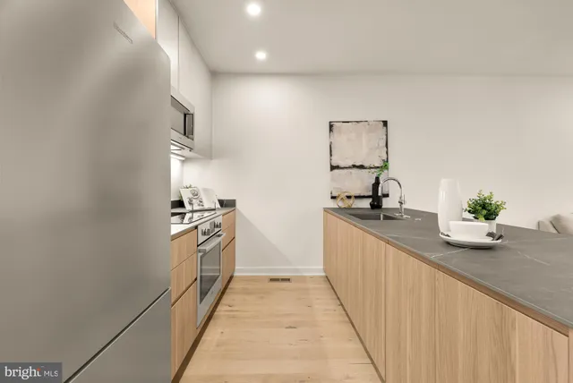 a kitchen with granite countertop a sink and a stove top oven