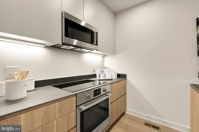 a kitchen with a stove and a microwave