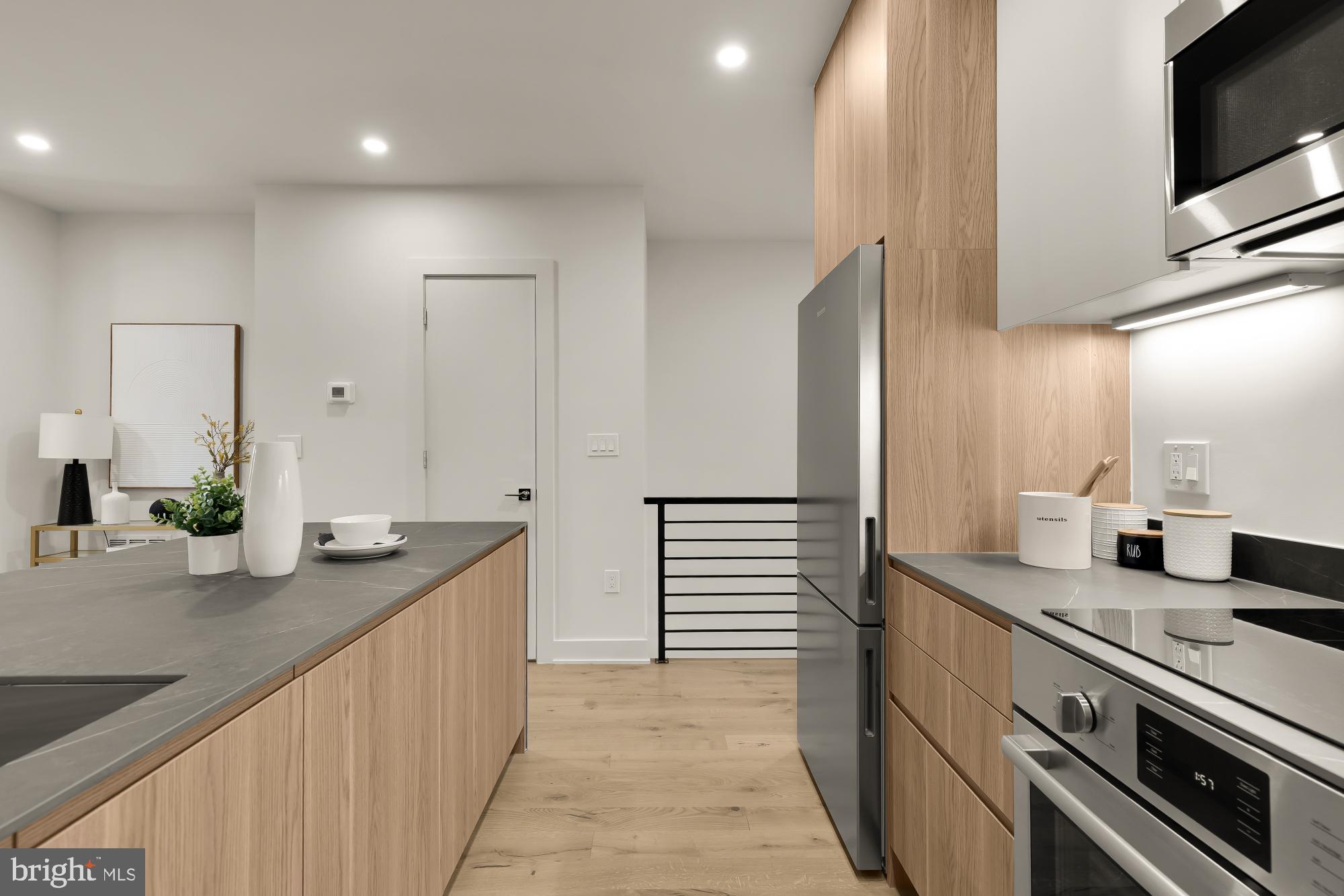 2647 41st Street Northwest, Unit 2 Washington, DC 20007 - Photo 8 of 31 a kitchen with stainless steel appliances granite countertop a sink and a stove