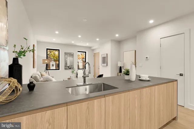 a kitchen with stainless steel appliances granite countertop a sink and a white cabinets