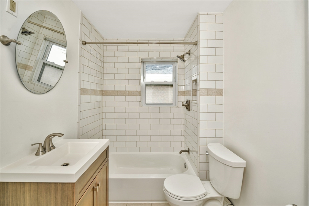492 Metropolitan Avenue, Unit 2 Boston, MA 02136 - Photo 11 of 15 a bathroom with a toilet a sink and mirror