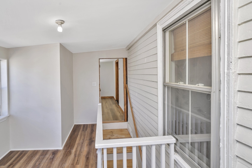 492 Metropolitan Avenue, Unit 2 Boston, MA 02136 - Photo 13 of 15 a view of a bedroom with wooden floor and windows
