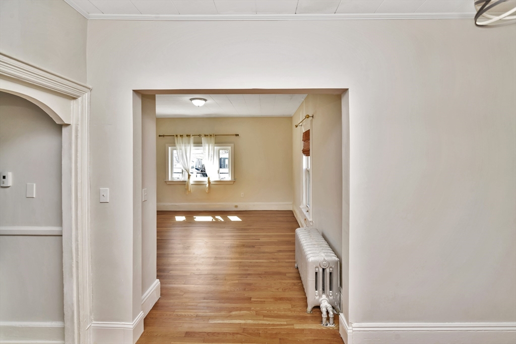 492 Metropolitan Avenue, Unit 2 Boston, MA 02136 - Photo 2 of 15 a view of a hallway with wooden floor and staircase