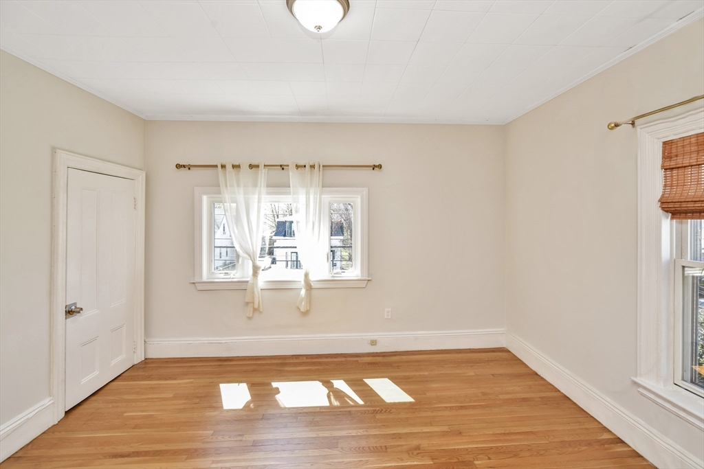 492 Metropolitan Avenue, Unit 2 Boston, MA 02136 - Photo 3 of 15 a view of empty room with wooden floor and fan
