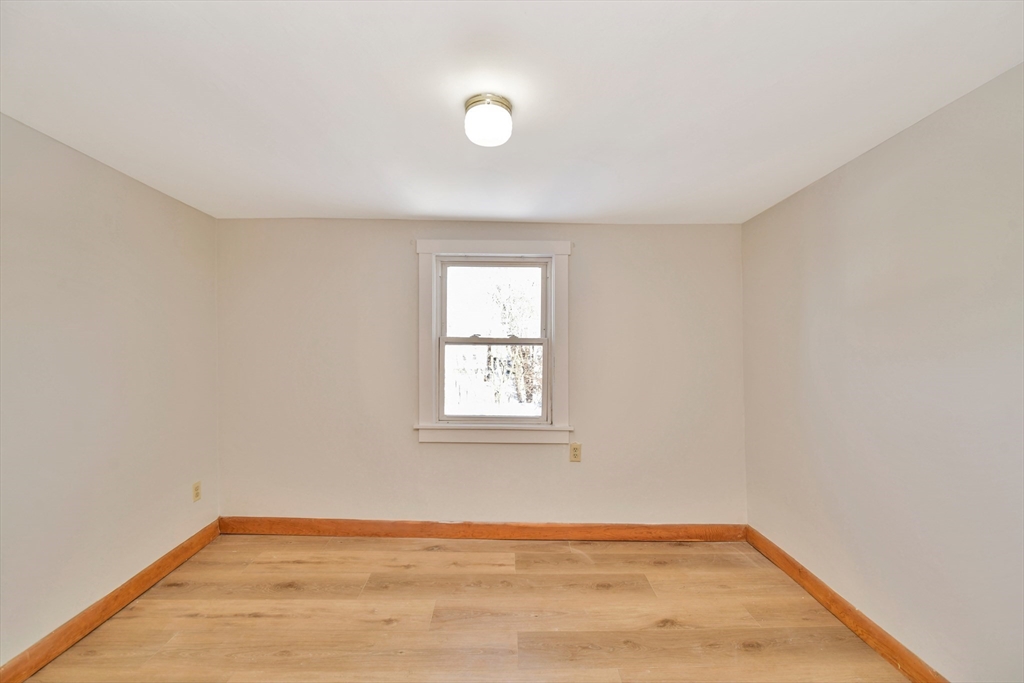 492 Metropolitan Avenue, Unit 2 Boston, MA 02136 - Photo 6 of 15 an empty room with wooden floor and windows