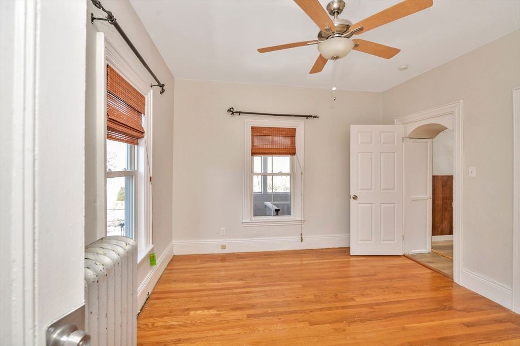 492 Metropolitan Avenue, Unit 2 Boston, MA 02136 - Photo 7 of 15 a view of an empty room with window and a kitchen