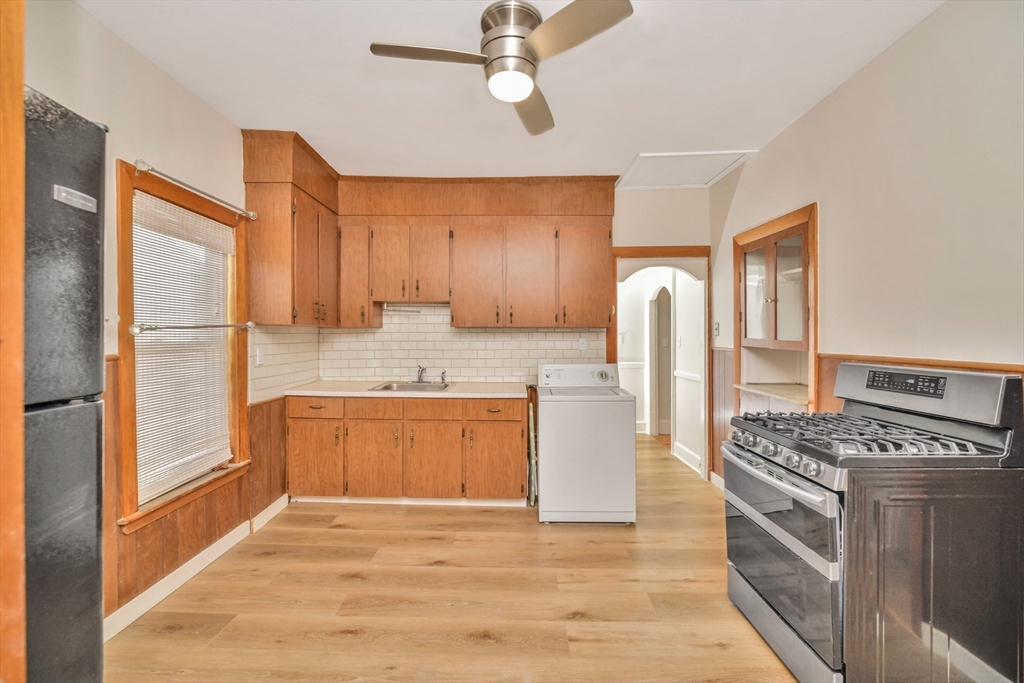 492 Metropolitan Avenue, Unit 2 Boston, MA 02136 - Photo 9 of 15 a kitchen with stainless steel appliances granite countertop a stove a sink and a refrigerator