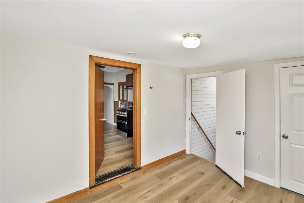 492 Metropolitan Avenue, Unit 2 Boston, MA 02136 - Photo 10 of 15 a view of a hallway with wooden floor and staircase
