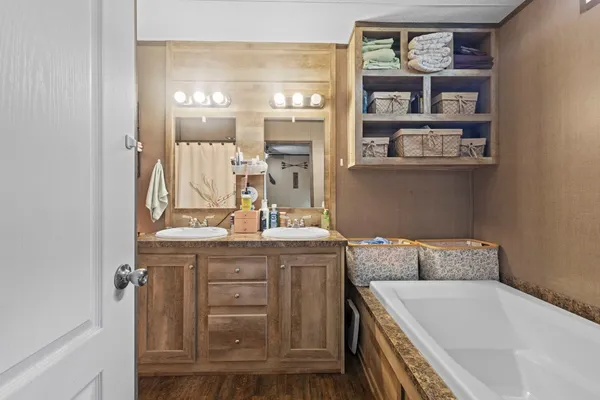a bathroom with a granite countertop bathtub and close view