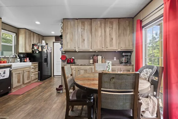 a kitchen with kitchen island granite countertop wooden cabinets and white appliances