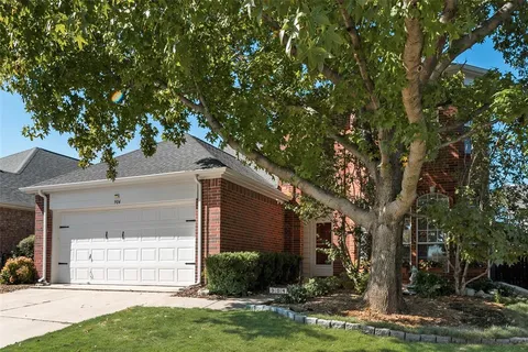 a front view of a house with a yard garage and outdoor seating