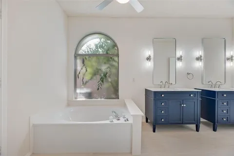 a bathroom with a double vanity sink and a mirror